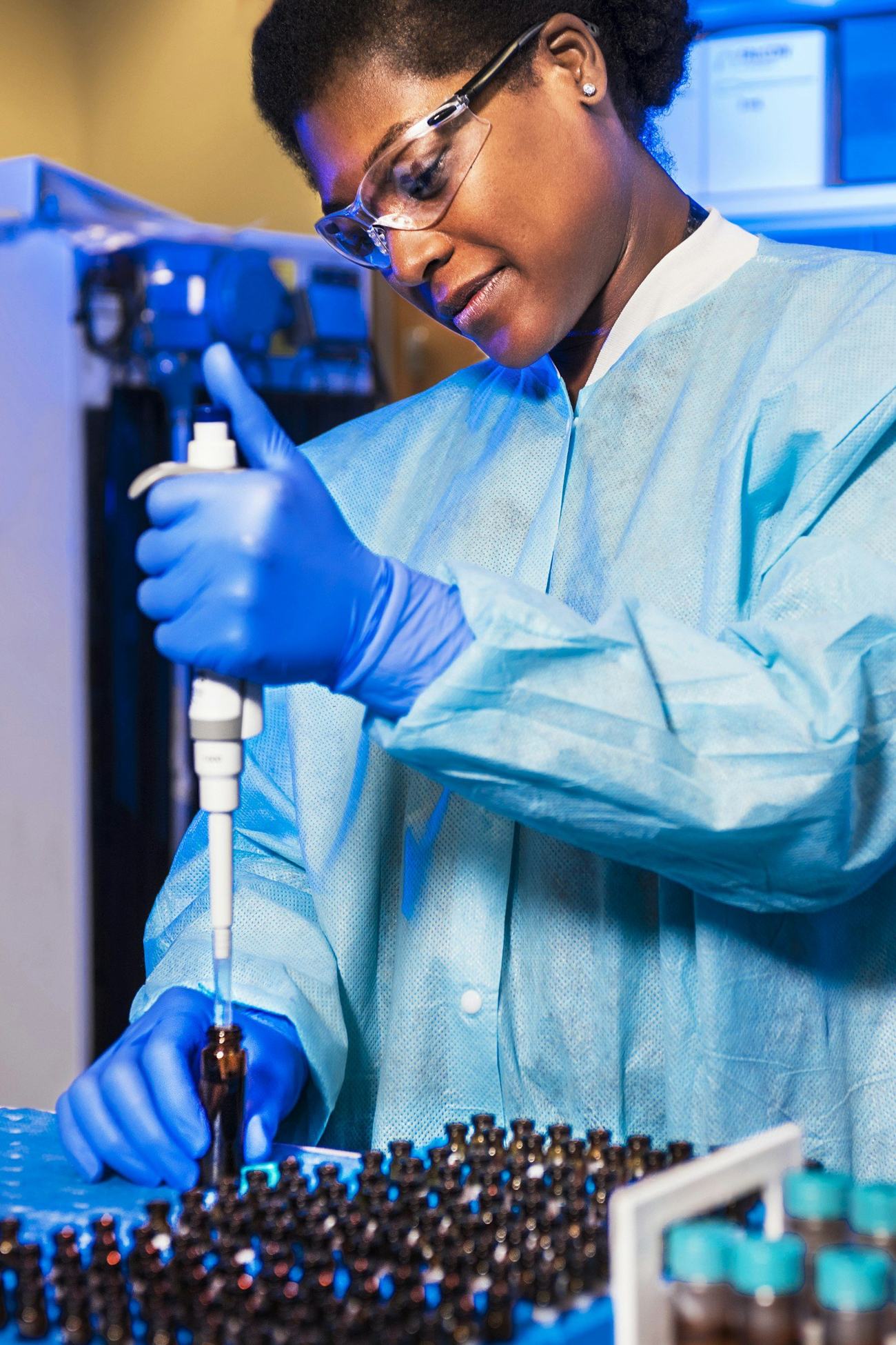 Pharmacist preparing a custom compound in gloves